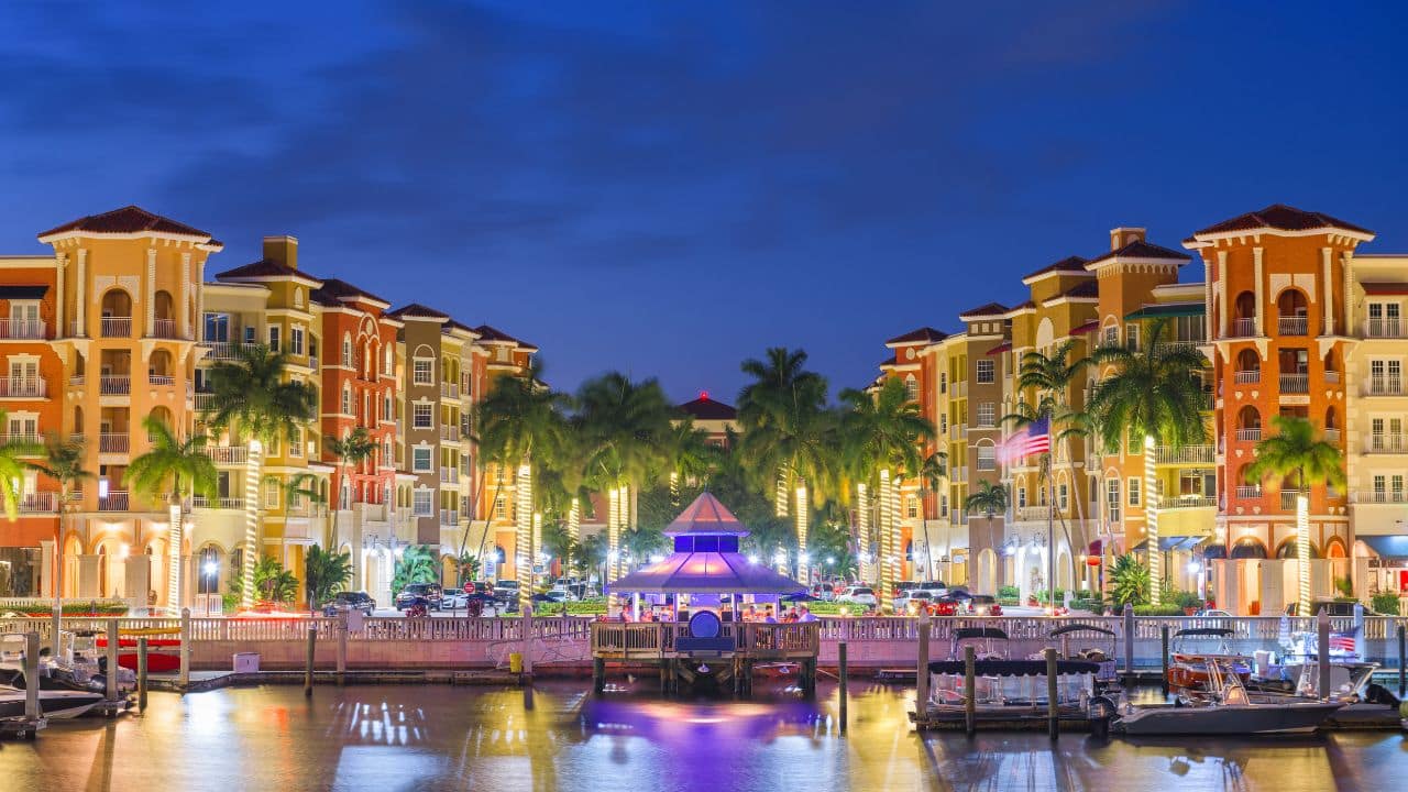 Naples, Florida, USA downtown cityscape on the bay at dusk.